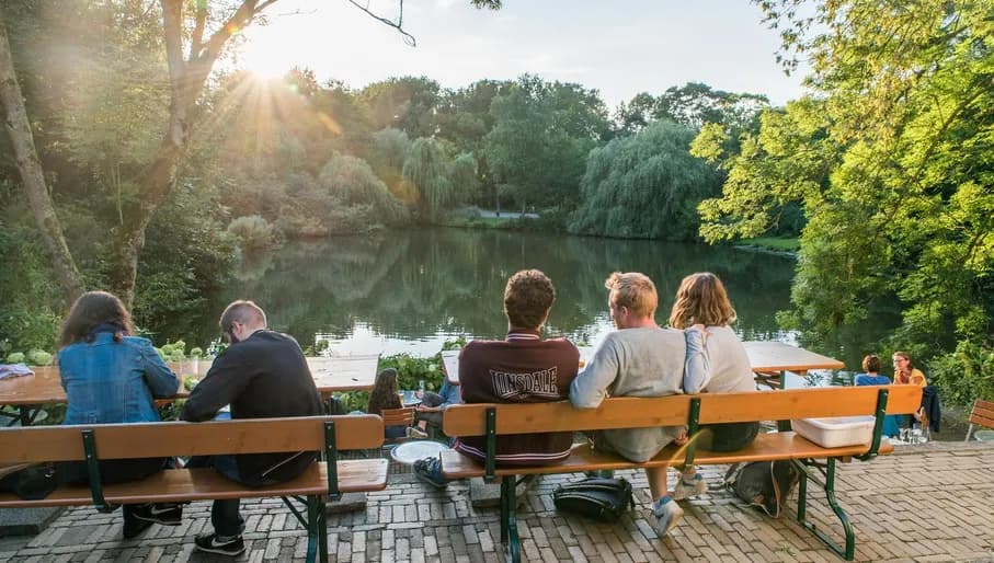 People sitting at terrace at 't Nieuwe Diep in Flevopark drinking jenever