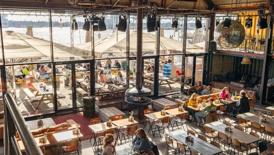 Pllek people sitting inside and out