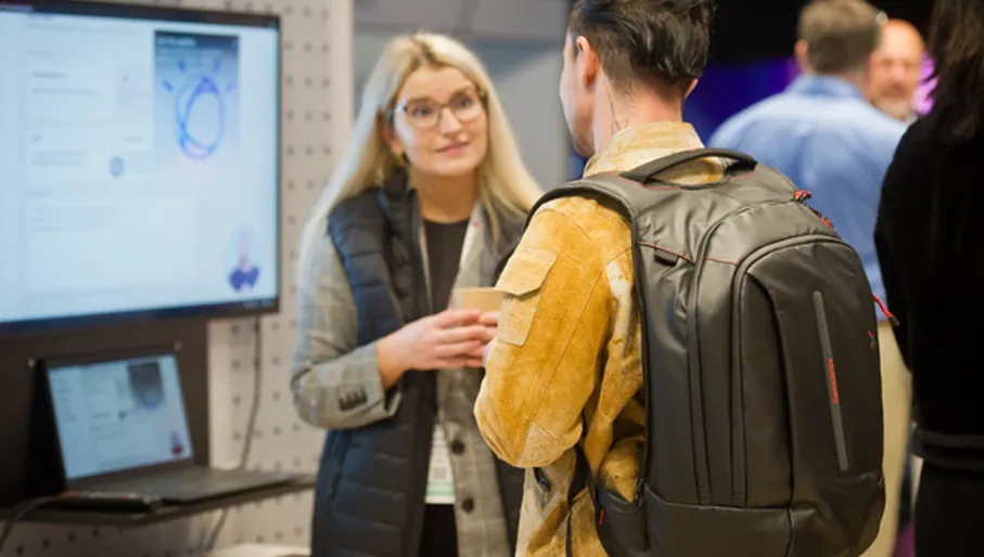 Man and woman conversing, Expo Hall, World Summit AI 2023 conference at Taets Art and Event Park